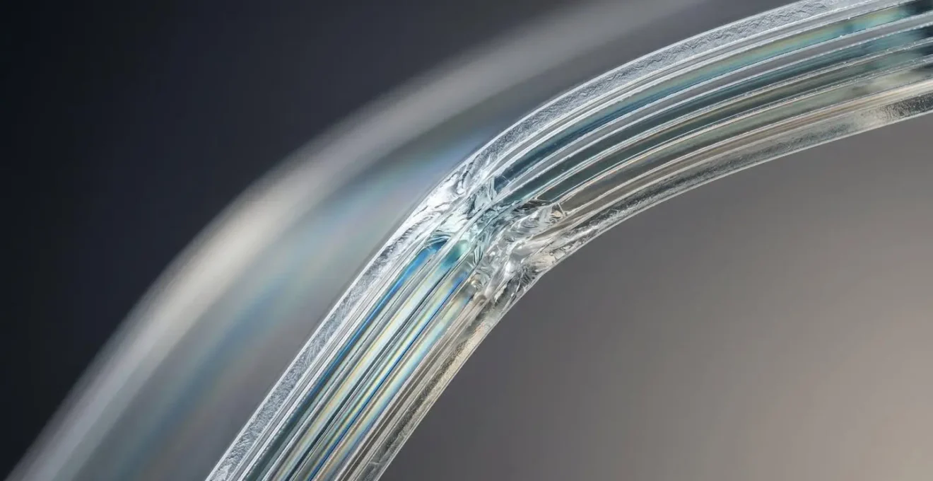 Macro detail photograph showing the layered structure and texture of ultra-thin glass used in foldable phone displays