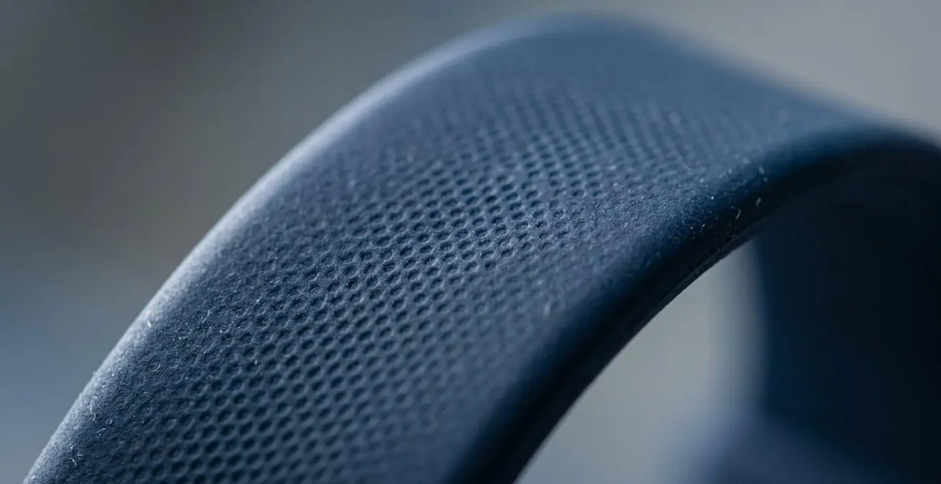 Close-up macro photograph of clean silicone smartwatch band showing textural detail and hypoallergenic material surface